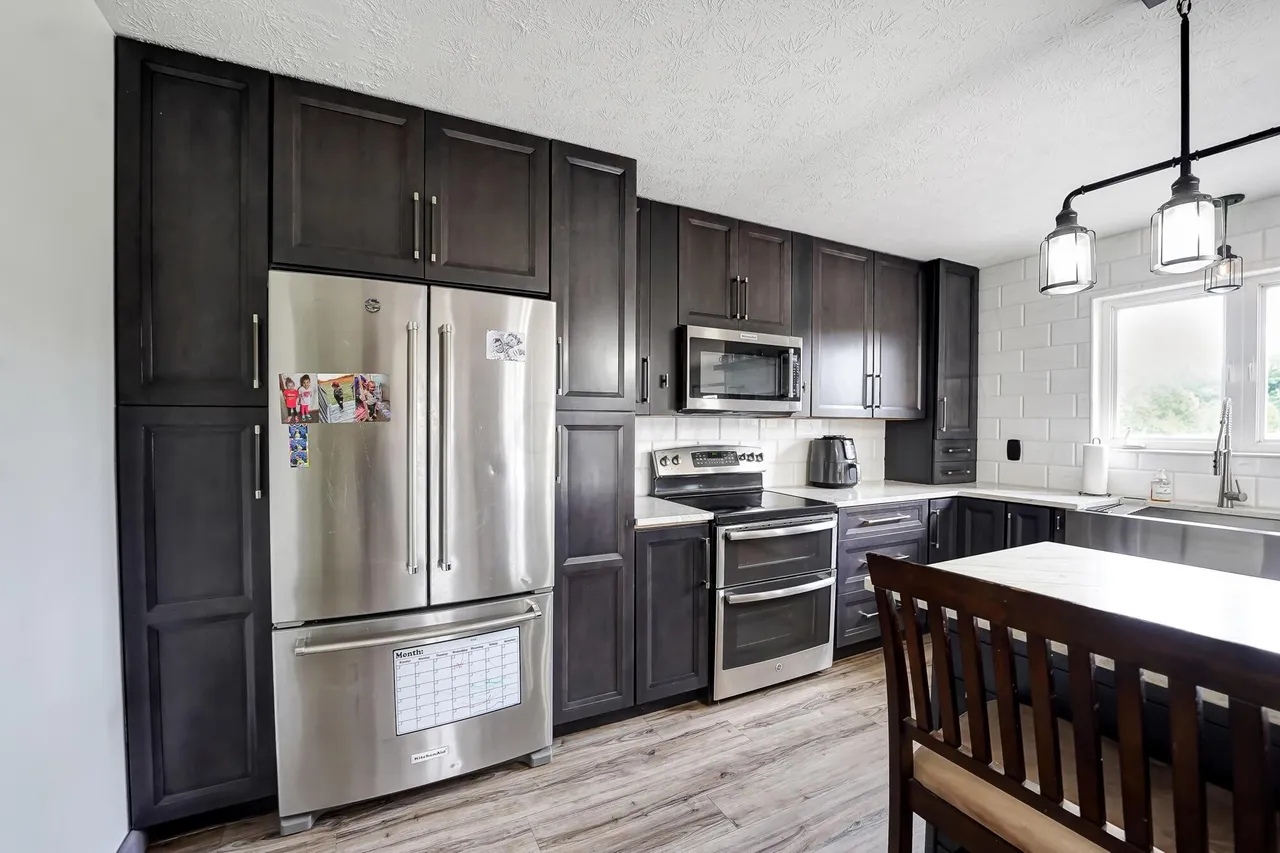 Open concept dining and kitchen with plank flooring